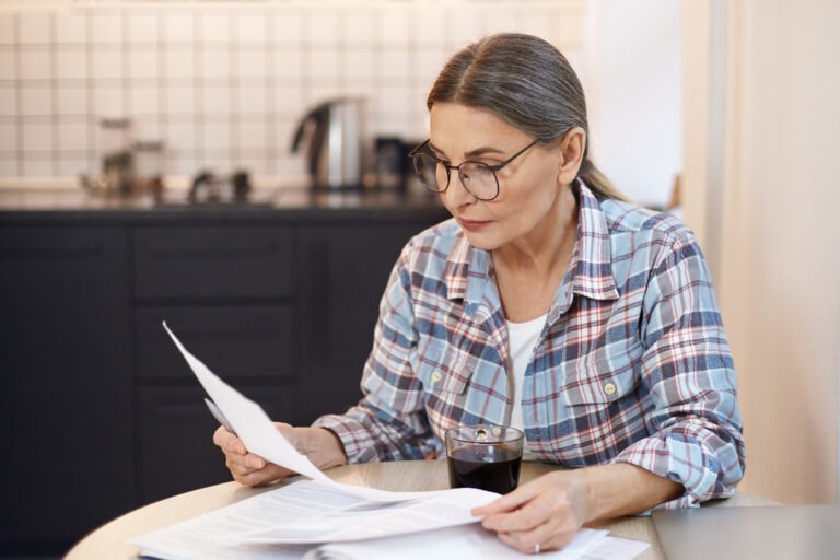 Woman in indoors, thinking about saving energy before installing solar panels.